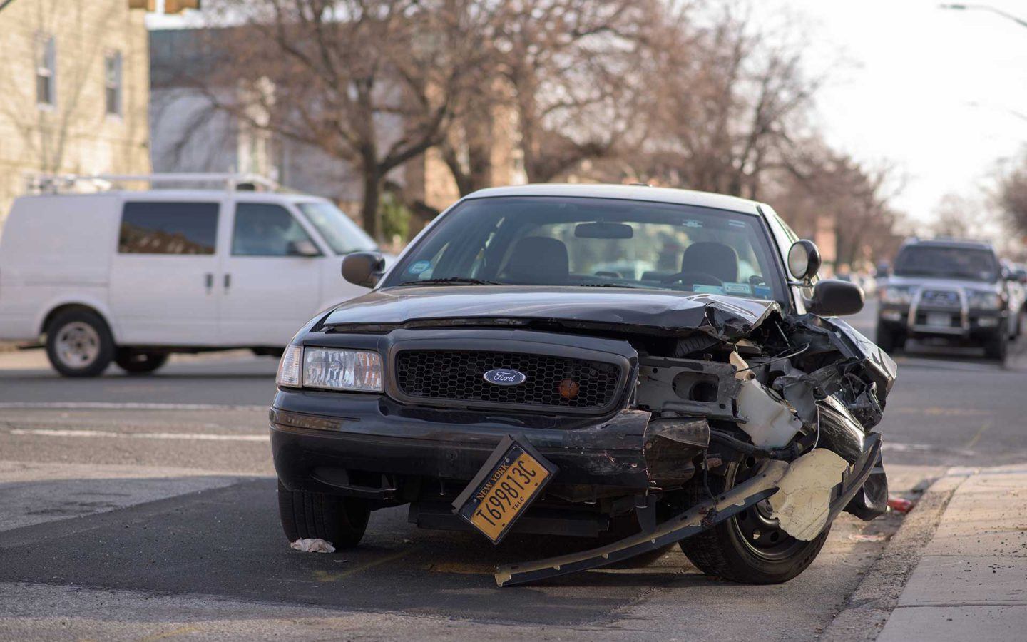 black ford car after a car accident with damaged front right bumper