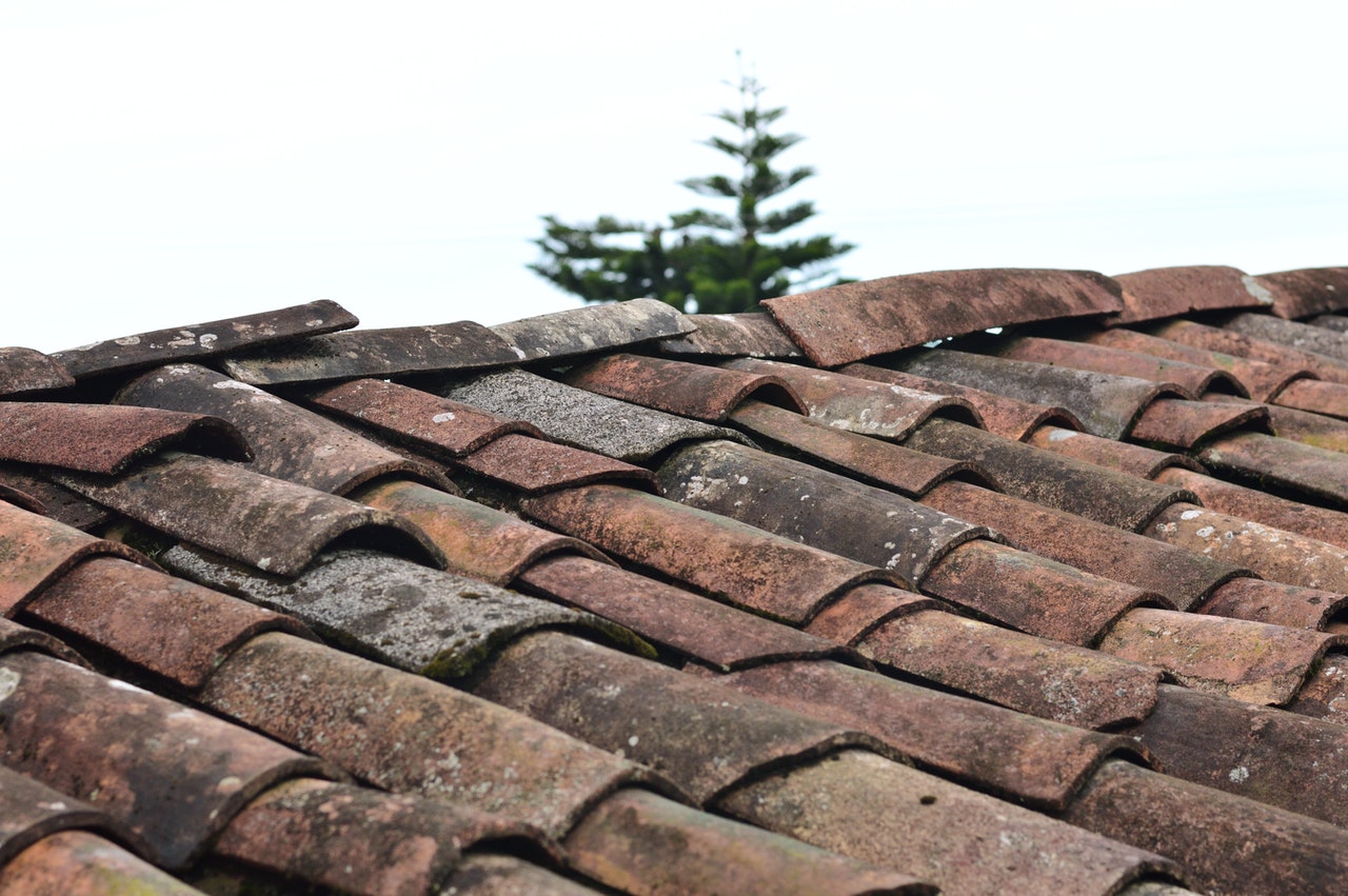 tiled roof with misaligned and loose tiles